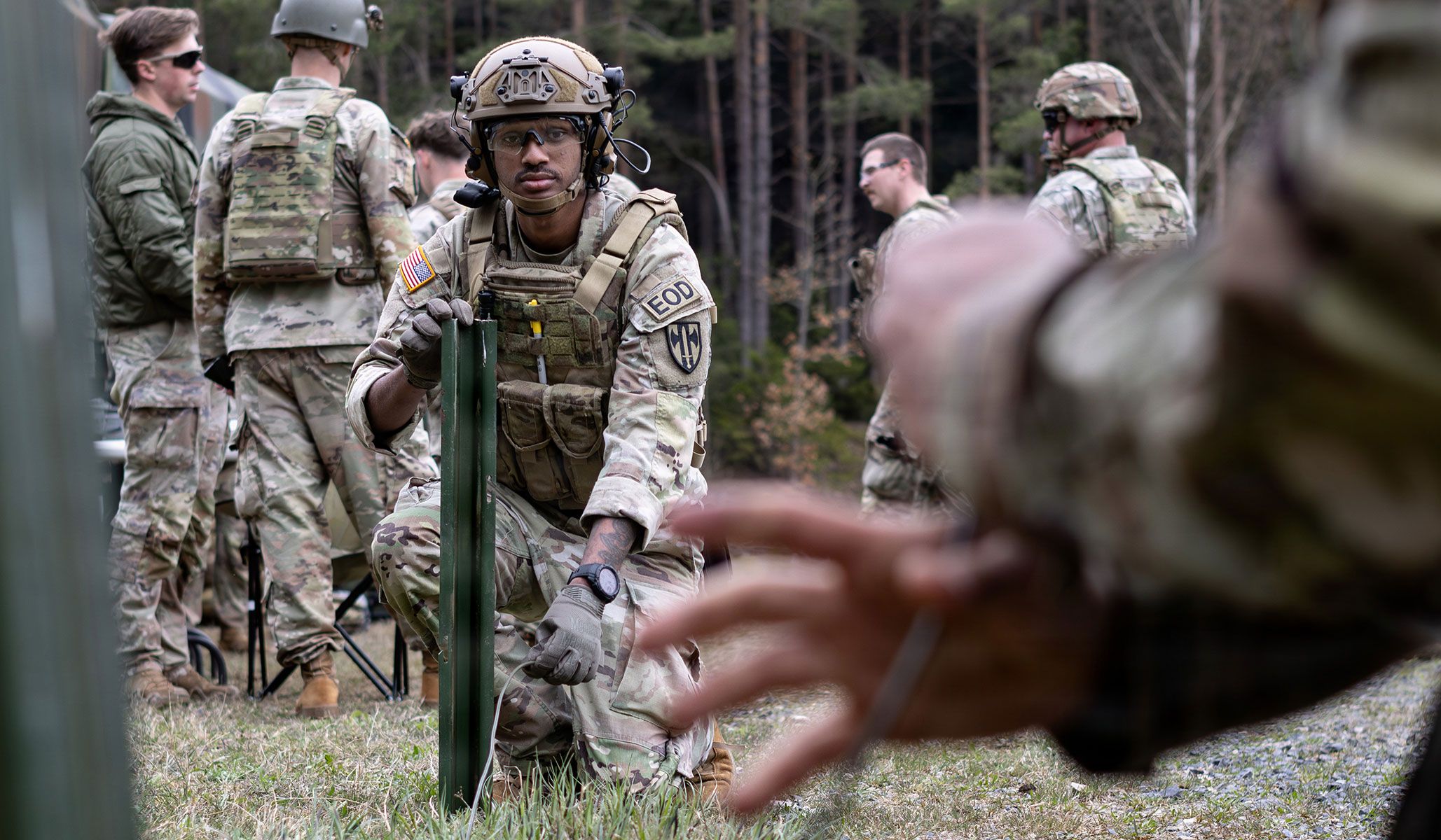 U.S. Army Specialist Nathen Wheeler, an Explosive Ordnance Disposal technician assigned to 702nd Ordnance Company, 18th Military Police Brigade, holds detonation cord to a measured length for use on the EOD demolition range at U.S. Army Garrison Bavaria, Germany, April 15, 2026.