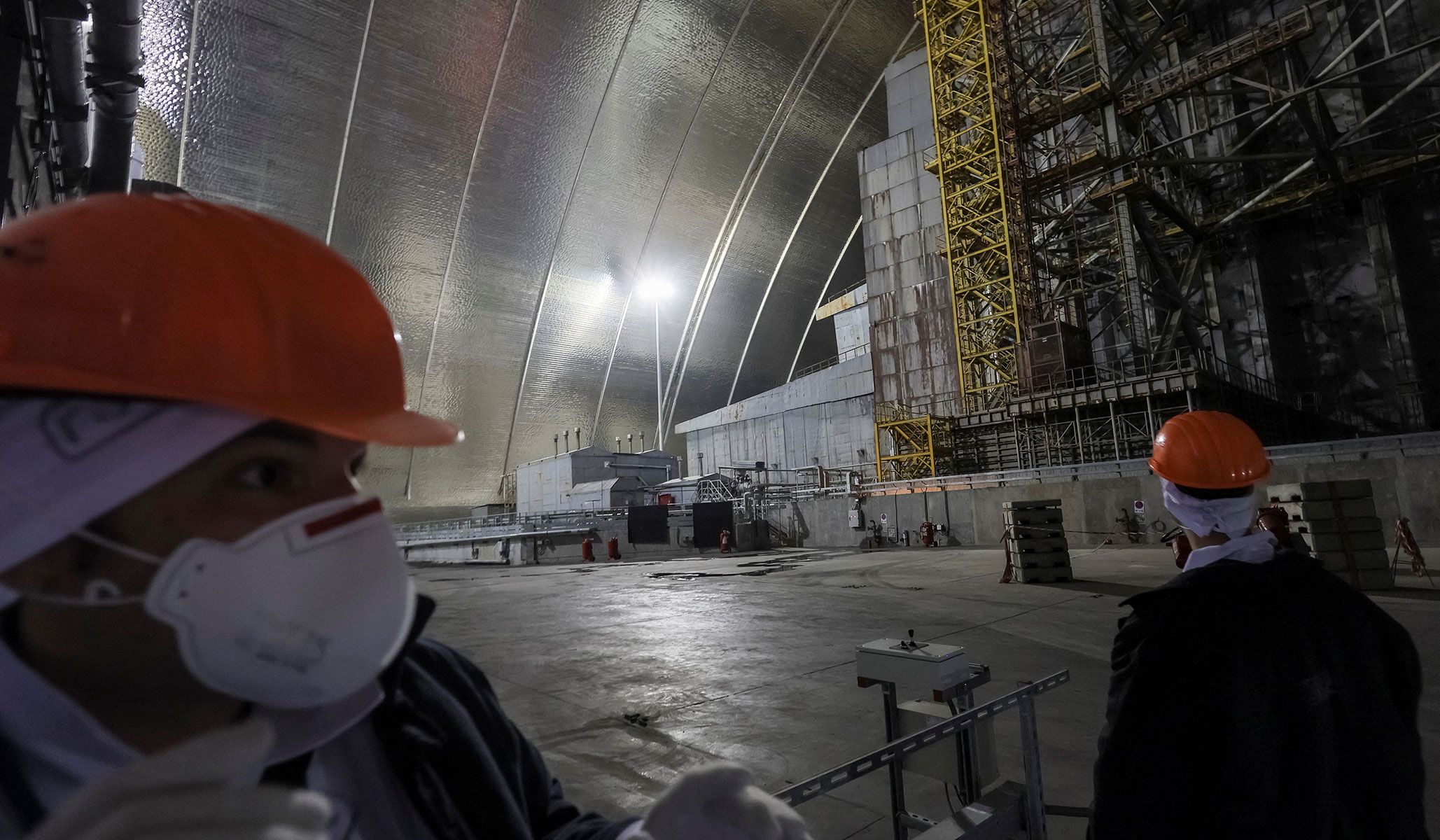 A visitor reacts as he visits an area next to the old sarcophagus covering the damaged fourth reactor, under the New Safe Confinement Structure at the Chernobyl nuclear power plant in Kyiv Region, Ukraine, April 22, 2026.