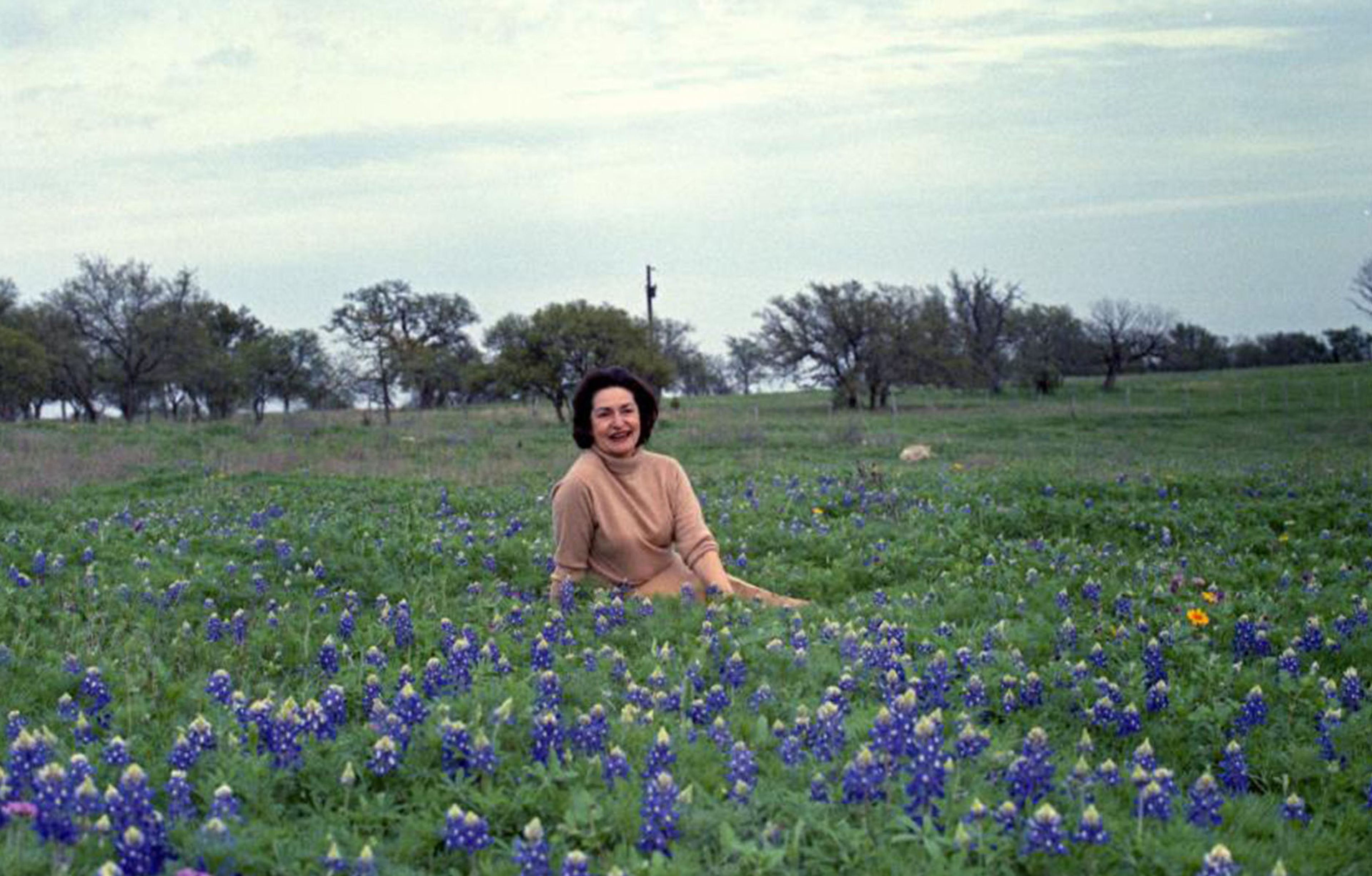 Lady Bird among bluebonnets. Among her causes were highway beautification, the study of wildflowers, and scenic preservation. She had money and brains and propelled LBJ’s career at crucial moments.