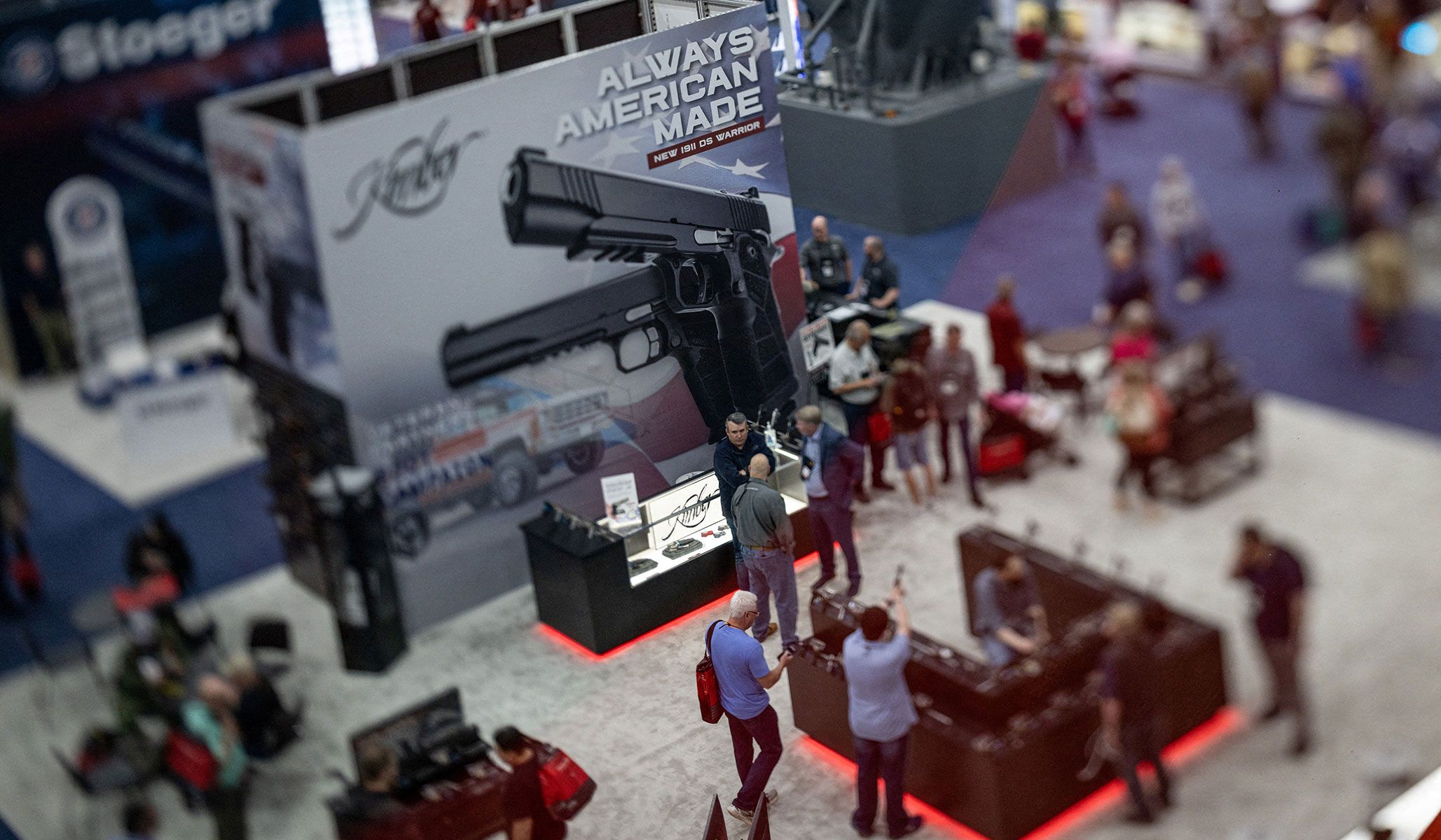 People visit an exhibitor's booth during the National Rifle Association's annual meetings and exhibits in Houston, Texas, April 17, 2026.