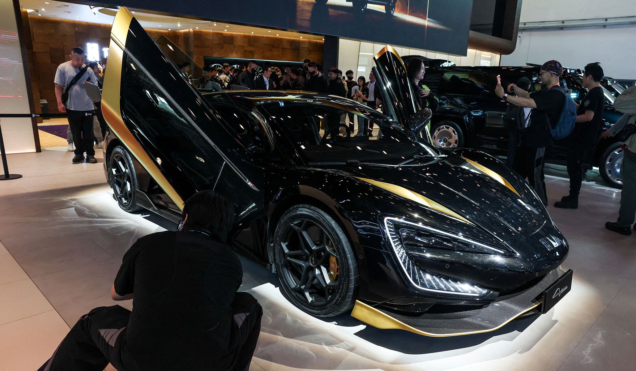 People gather next to BYD's premium brand Yangwang's model U9 Xtreme at the Beijing International Automotive Exhibition in Beijing, China, April 24, 2026.