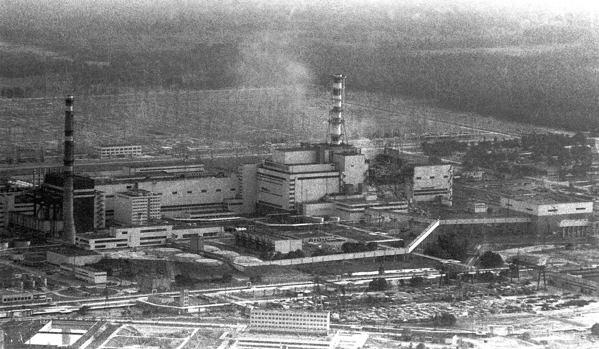 The Chernobyl nuclear power plant shortly after the explosion of its still smoking fourth reactor, 1986.