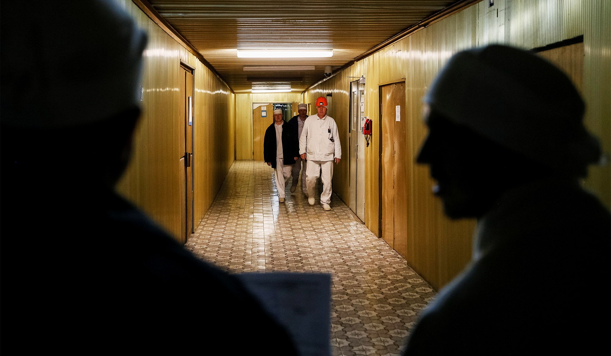 Employees walk through the corridor of the stopped third reactor at the Chernobyl nuclear power plant in Chernobyl, Ukraine, April 20, 2018.