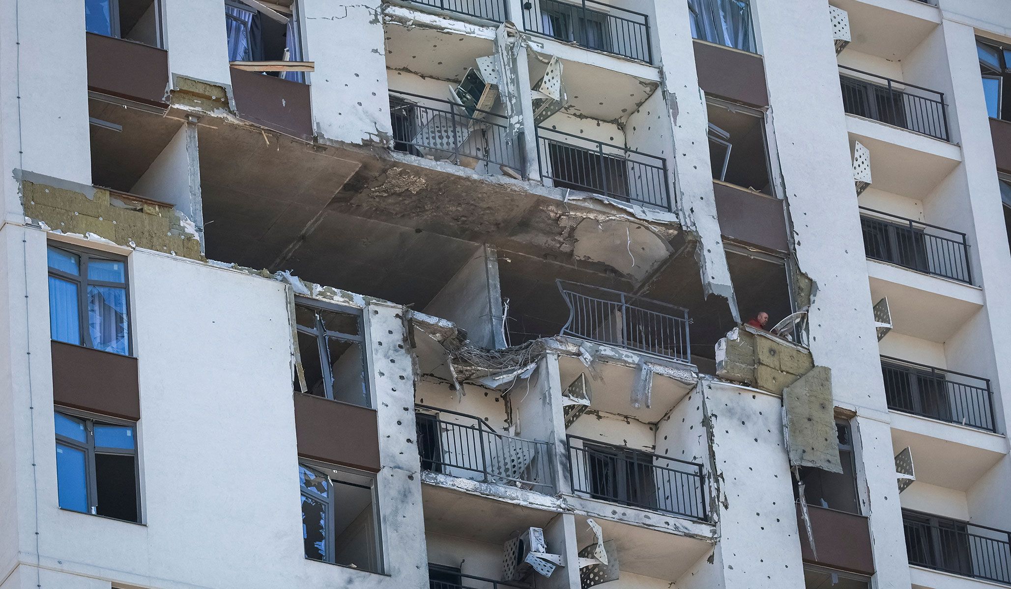 A resident removes debris from his flat in an apartment building damaged by a Russian drone strike in Odesa, Ukraine, April 27, 2026.