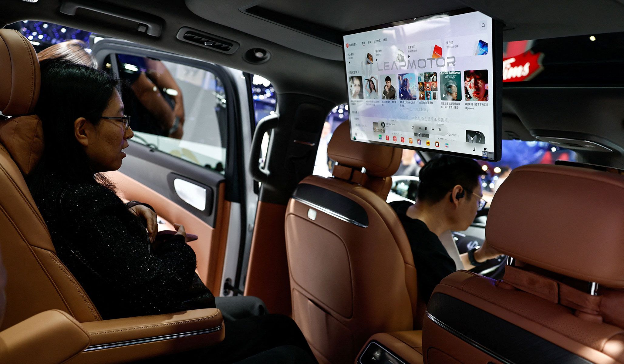 Visitors sit inside the Leapmotor D19 SUV displayed during the Beijing International Automotive Exhibition in Beijing, China, April 24, 2026.