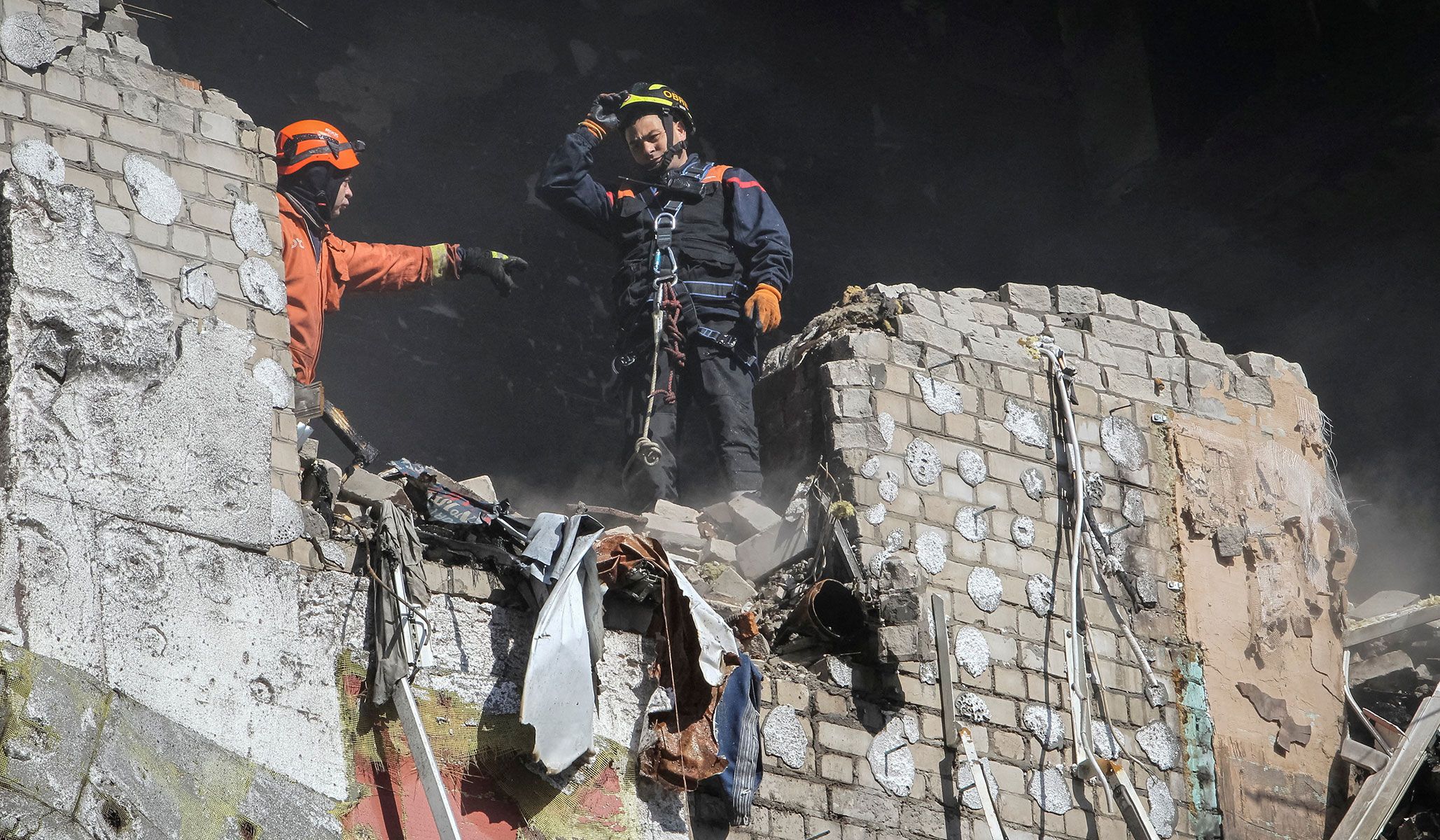 Rescuers work at the site of an apartment building hit by a Russian drone strike in Dnipro, Ukraine, April 23, 2026.