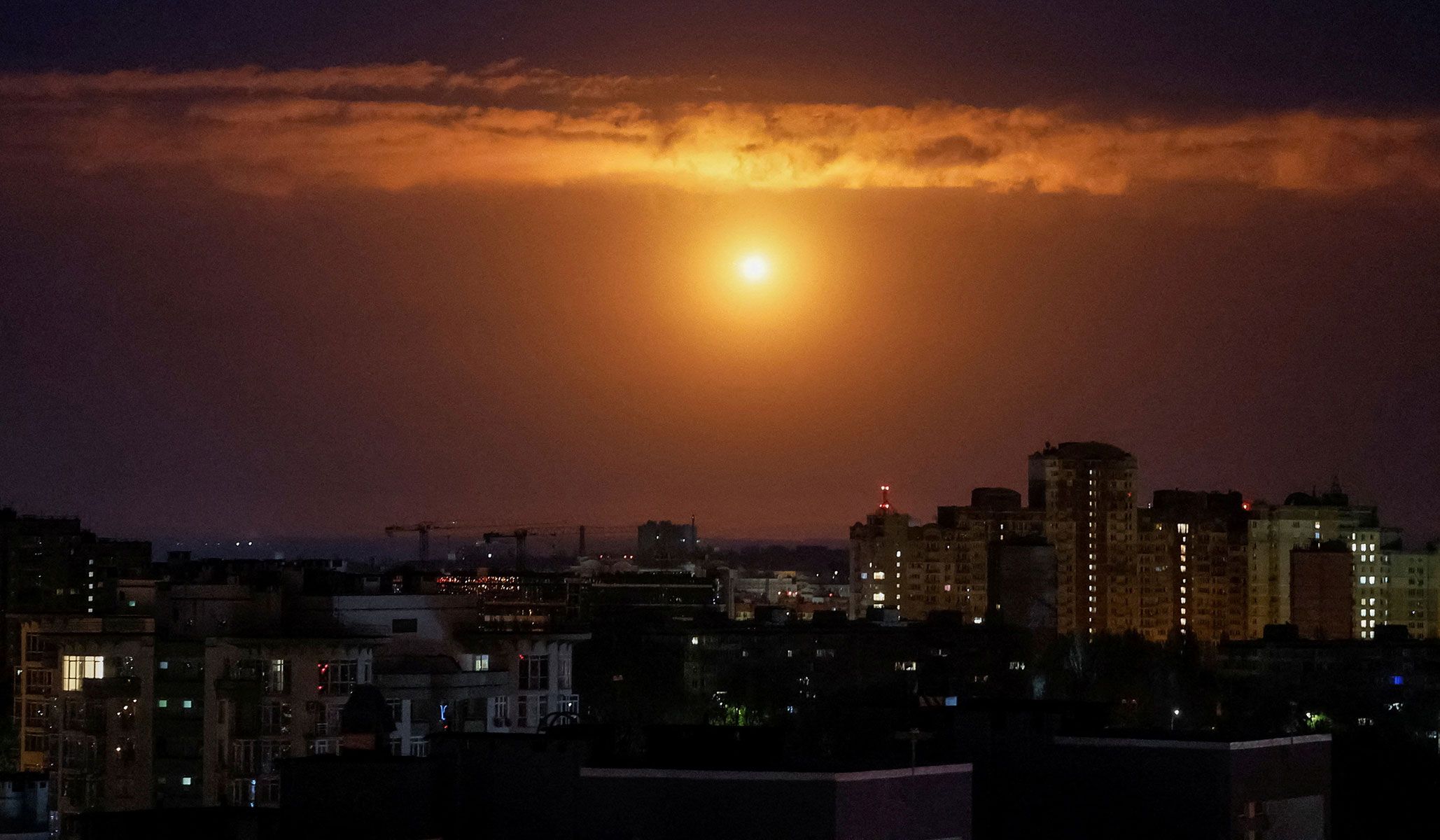 An explosion over the city as Ukrainian servicemen hit a Russian drone during a Russian missile and drone strike in Kyiv, Ukraine, April 25, 2026.