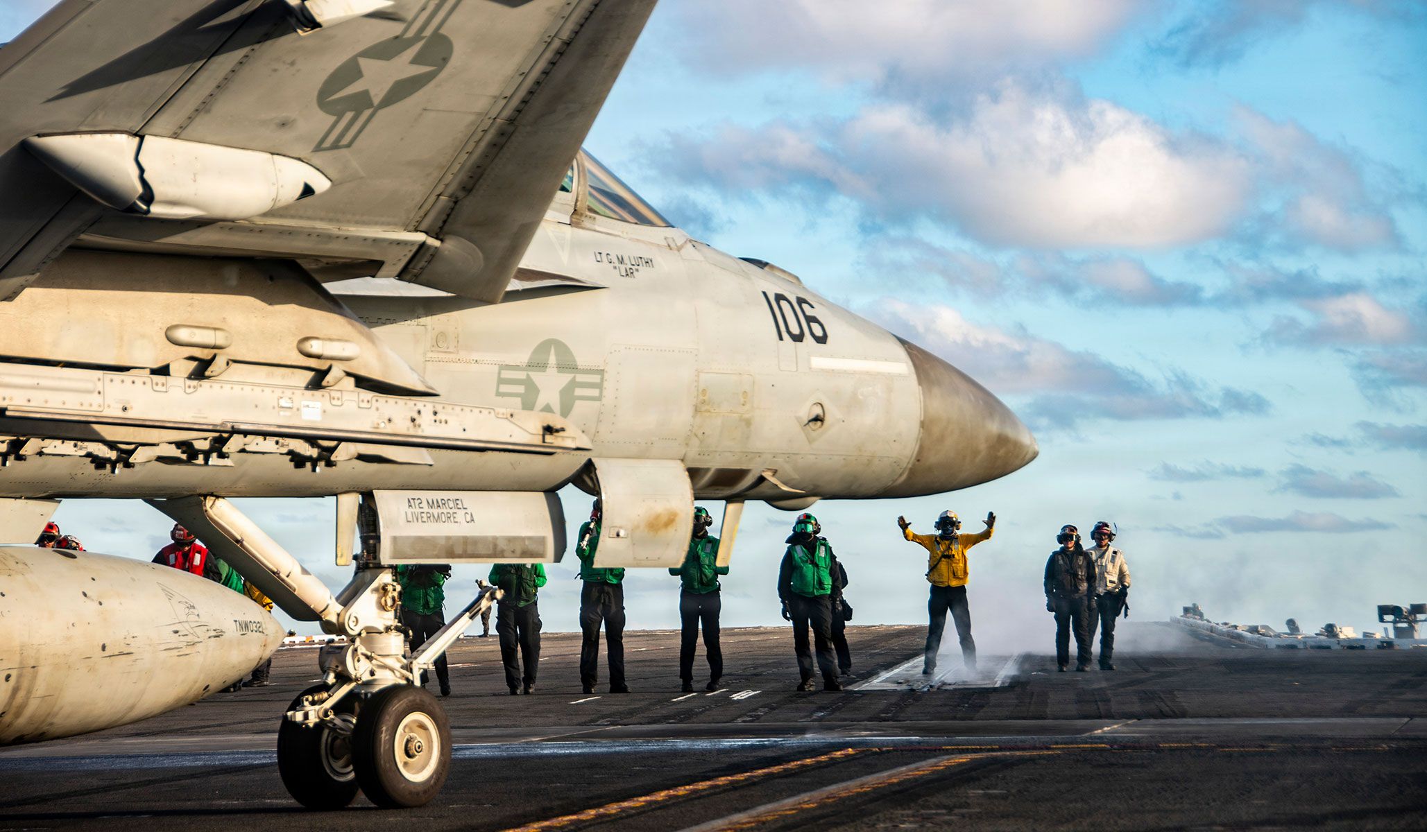 A U.S. Navy sailor guides an F/A-18E Super Hornet attached to the “Kestrels” of Strike Fighter Squadron VFA-137 into position to launch from the flight deck of the Nimitz-class aircraft carrier USS <i>Nimitz</i> (CVN-68), under way in the Pacific Ocean, April 14, 2026.