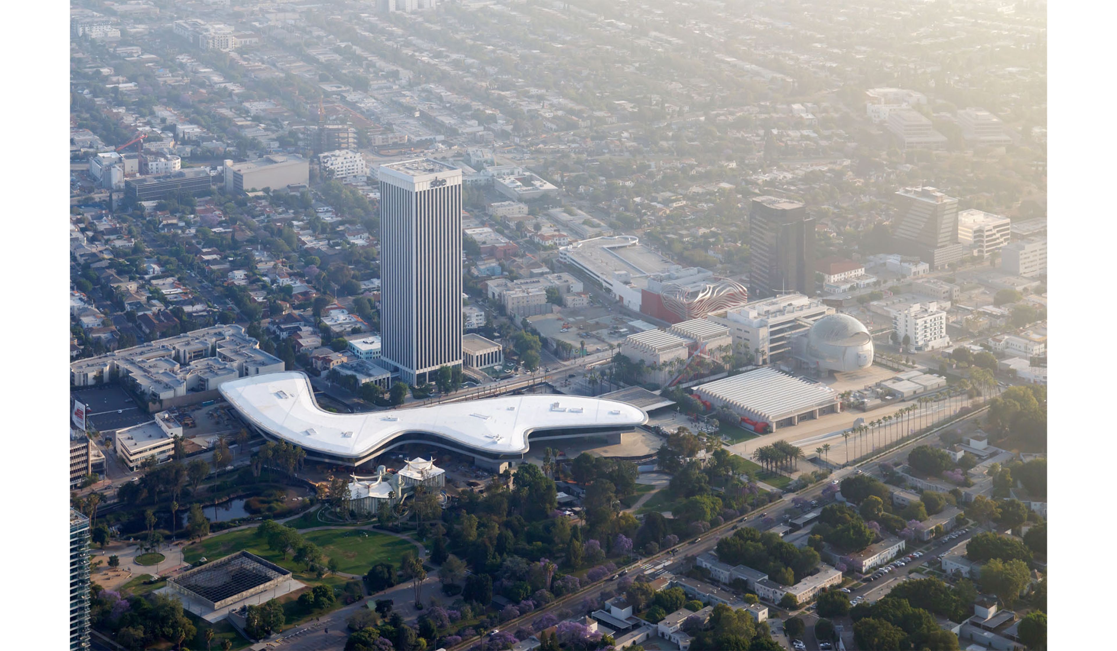 Aerial view of LACMA buildings, including David Geffen Galleries in the context of Miracle Mile.
