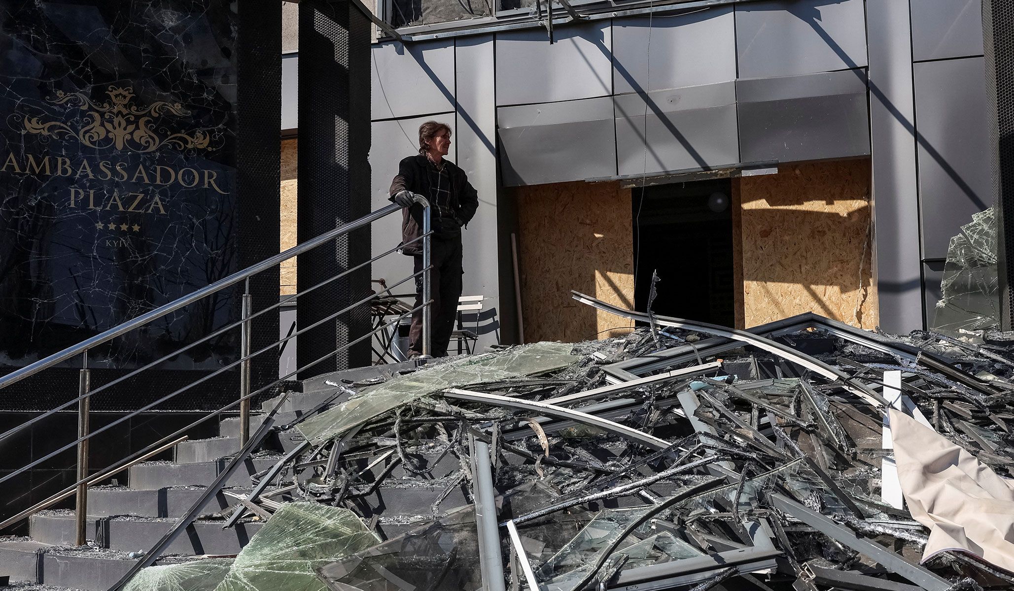 A man stands near a hotel hit by a Russian missile and drone strike in Kyiv, Ukraine, April 17, 2026.