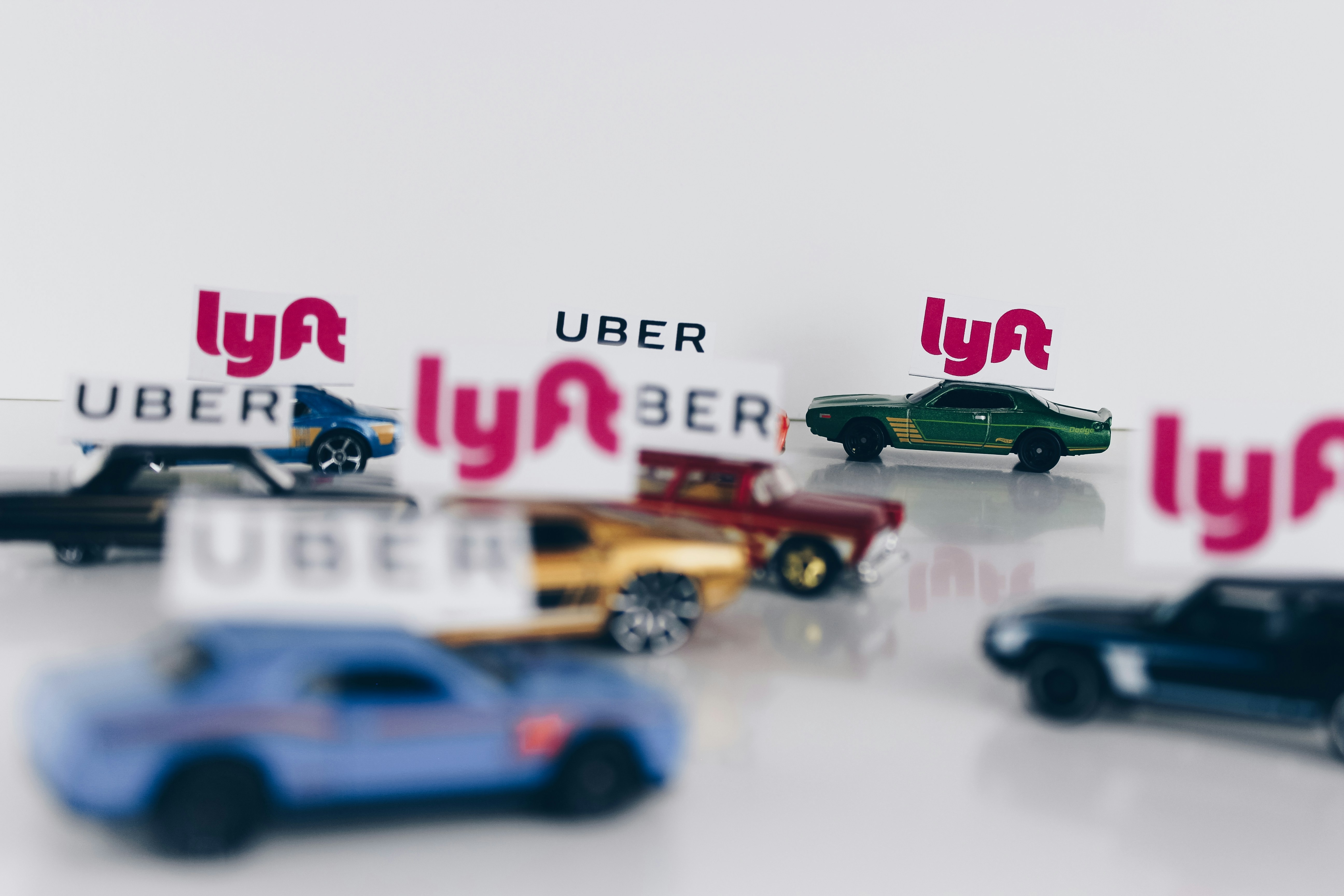 Image Toy cars topped with Uber and Lyft signs representing rideshare driver negligence accidents in New Jersey