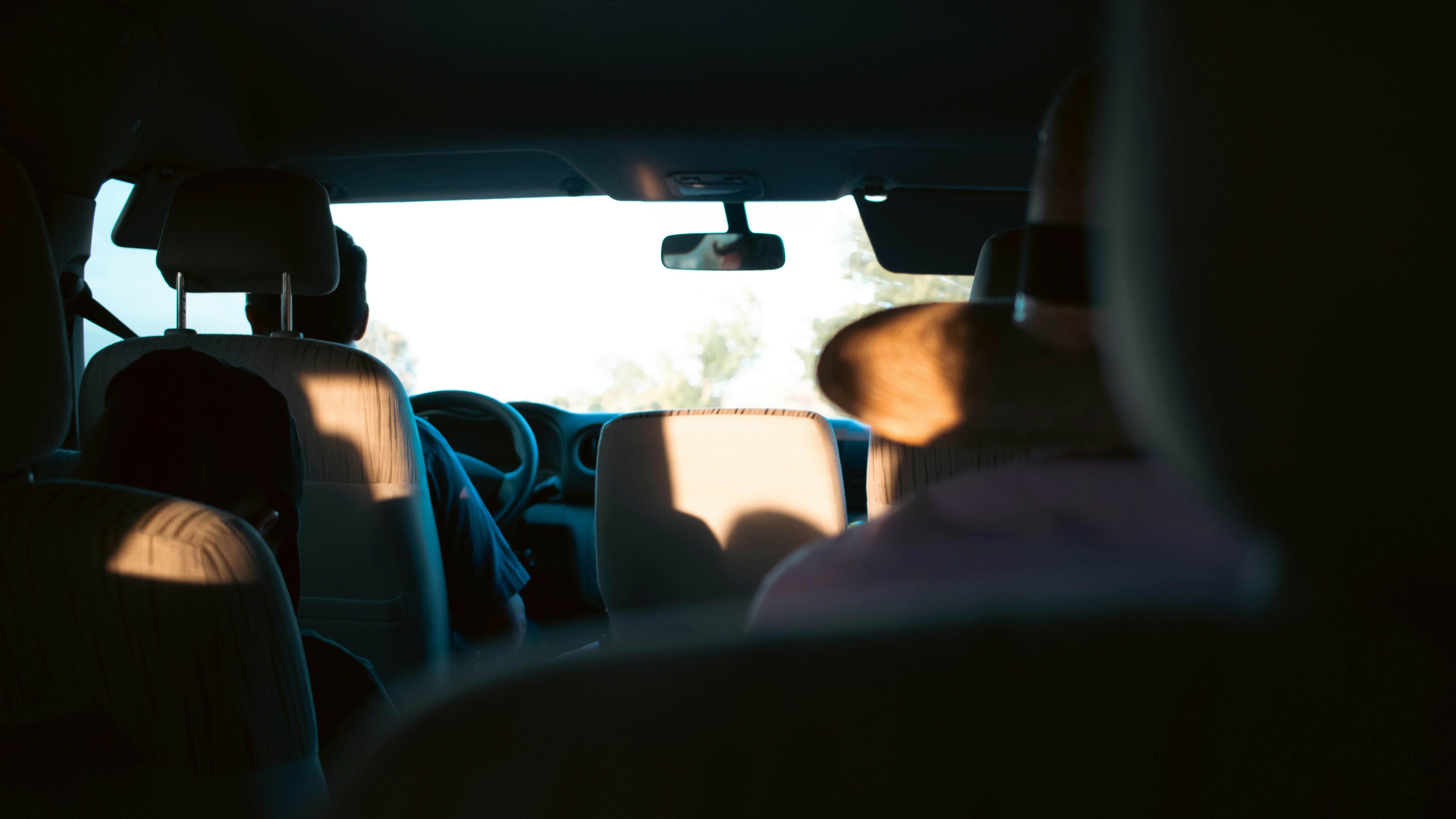 View from the back seat of a rideshare vehicle in New Jersey showing a passenger riding behind the driver