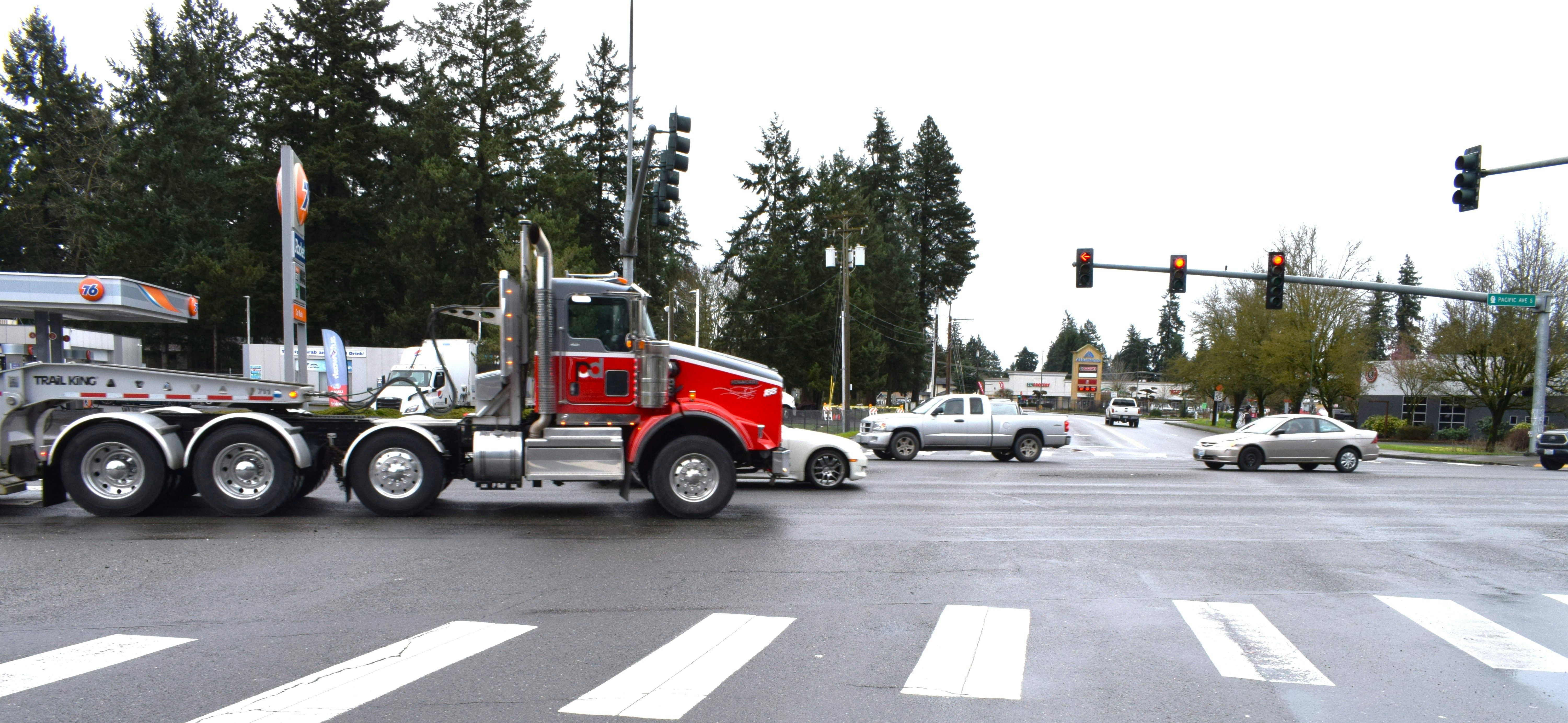 Commercial vehicle at a busy intersection after a traffic incident involving multiple cars