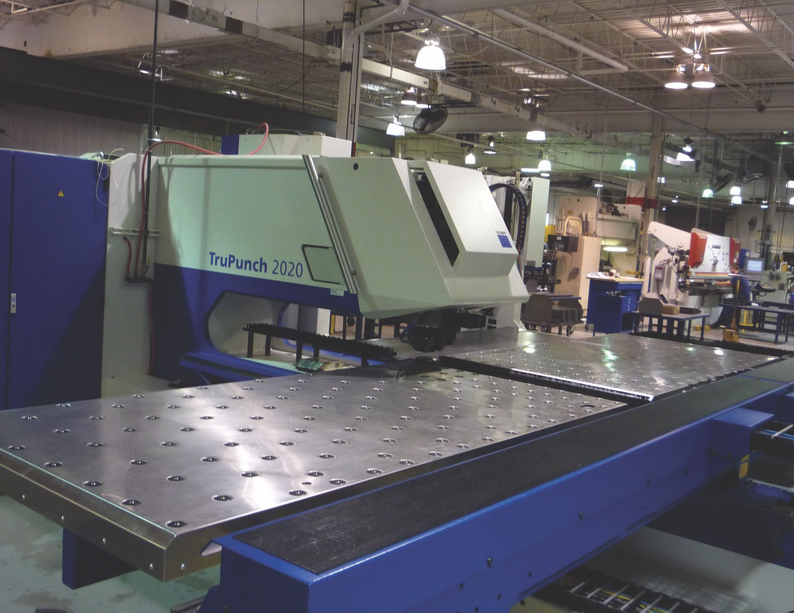 TruPunch 2020 punch press with a long perforated work table on the factory floor