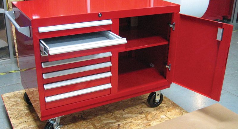 Red mobile steel cabinet on casters with an open drawer and an open shelf compartment