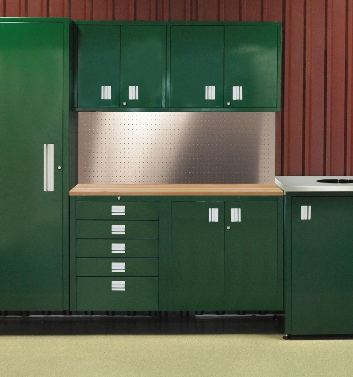 Green powder-coated steel storage system with tall locker, upper cabinets, drawers and a stainless backsplash