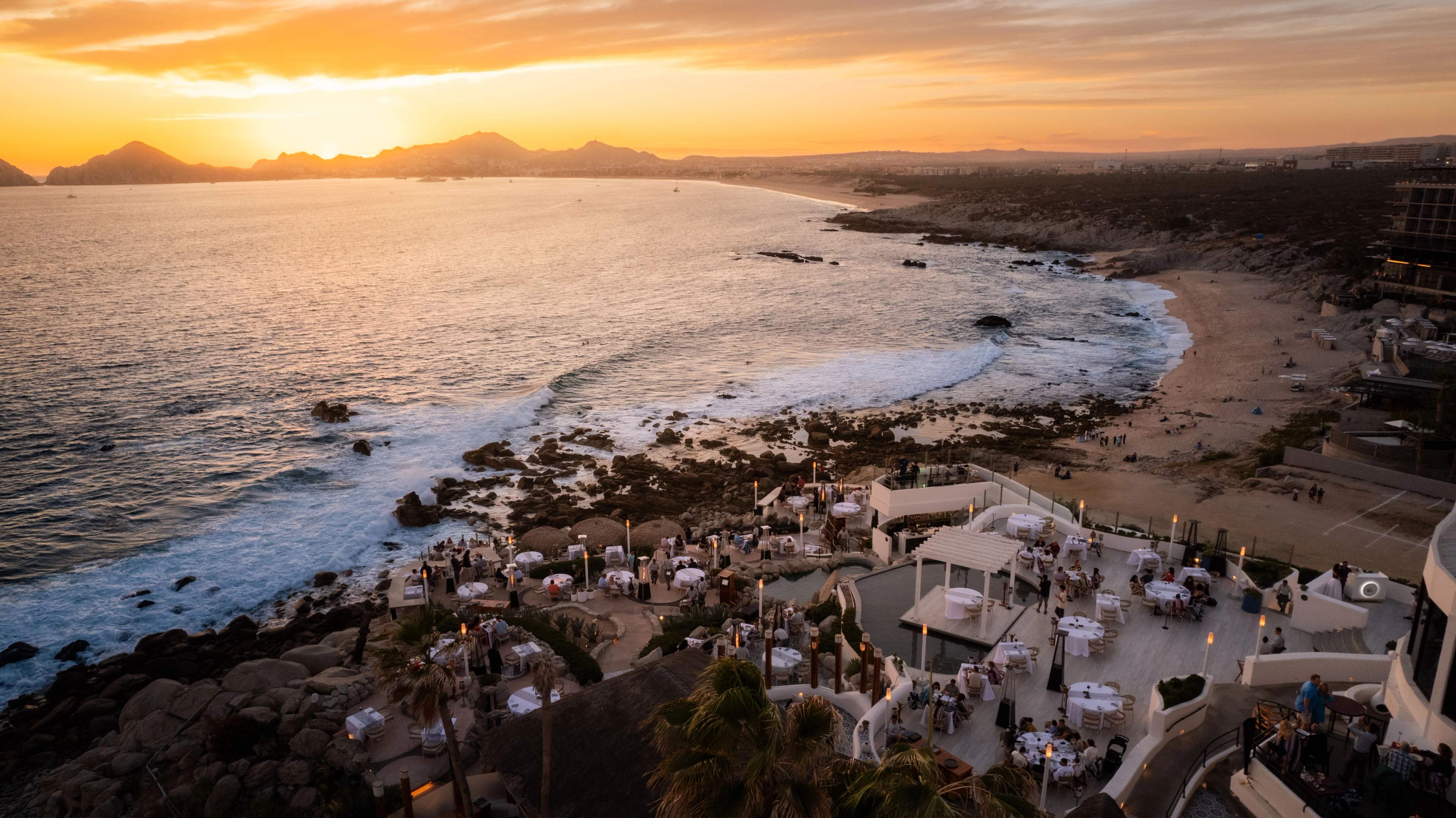 Puesta de sol cruzando la bahía sobre las terrazas de Sunset Monalisa