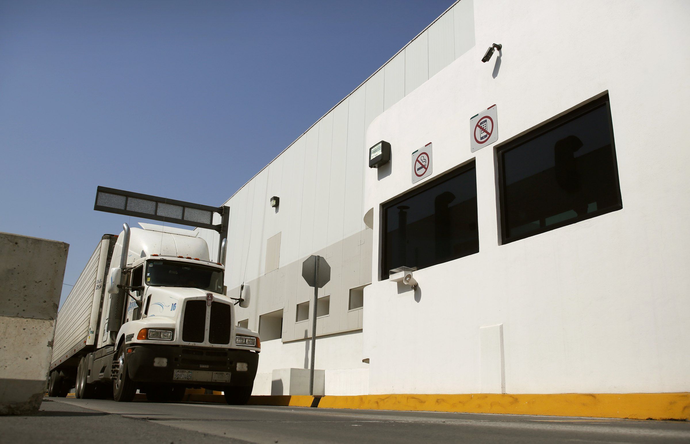 Camión de carga blanco pasa por un control de preclearance en Otay Mesa, en la frontera México-Estados Unidos.