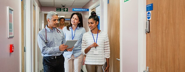 A group of hospital social workers walking in the hallway