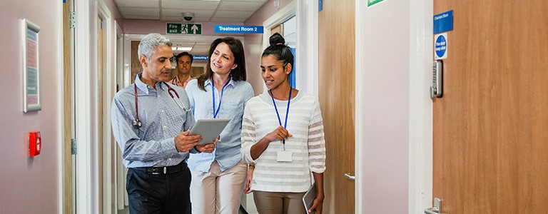 A group of hospital social workers walking in the hallway