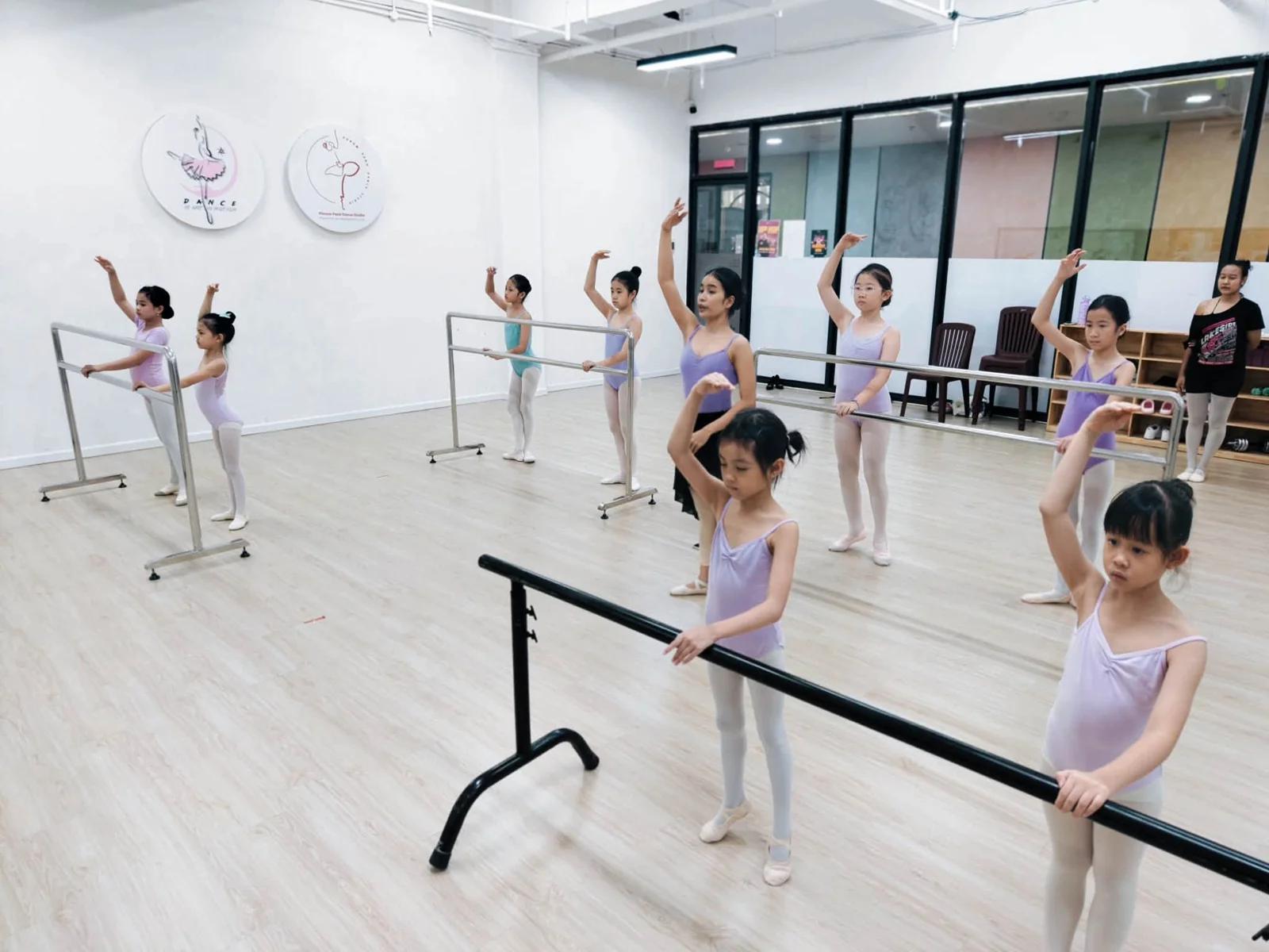 Young ballet students practise at the barre in AAA’s Funmall TK studio.