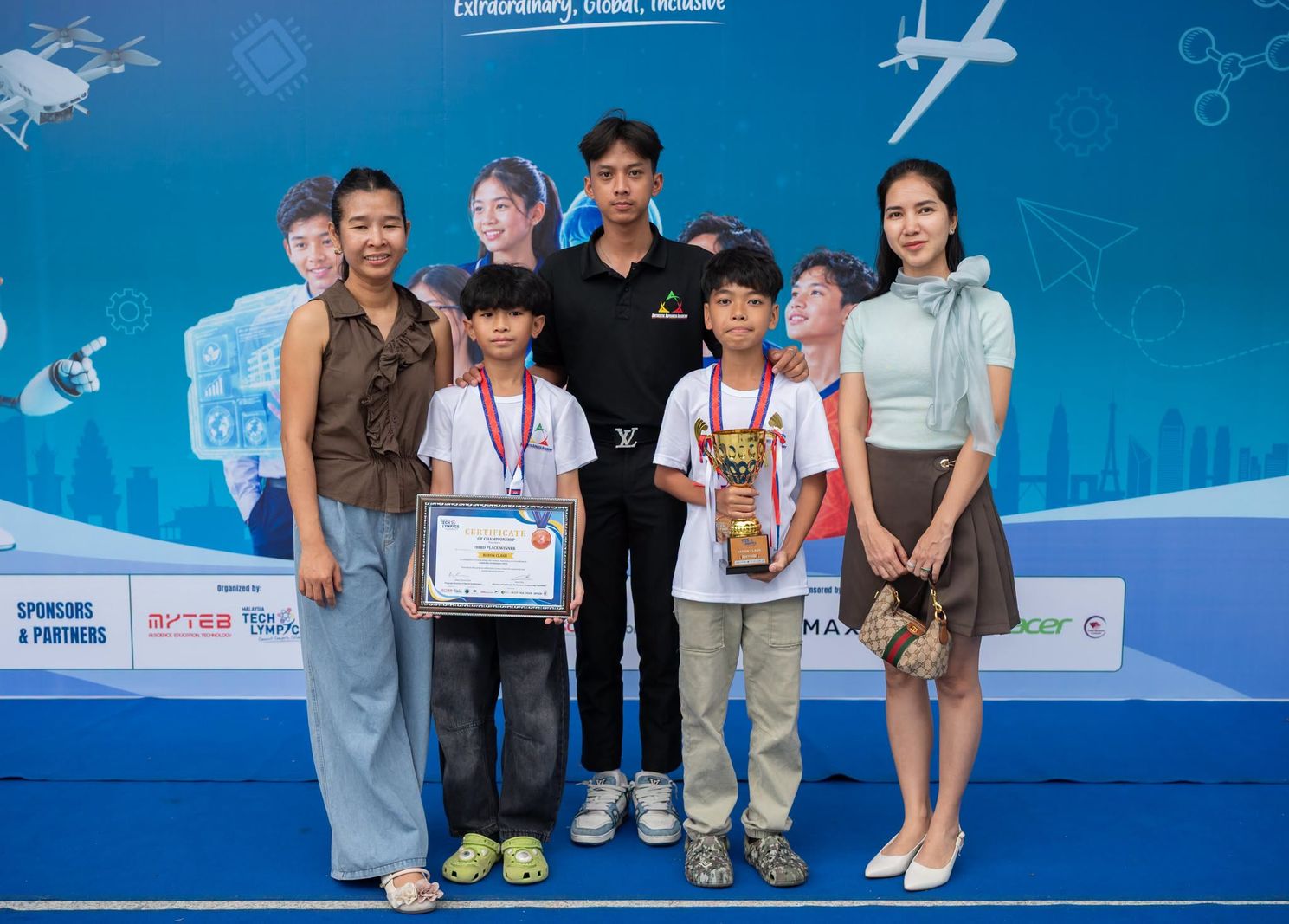 AAA Robotics students with their third-place trophy and certificate at Cambodia Techlympics 2026.