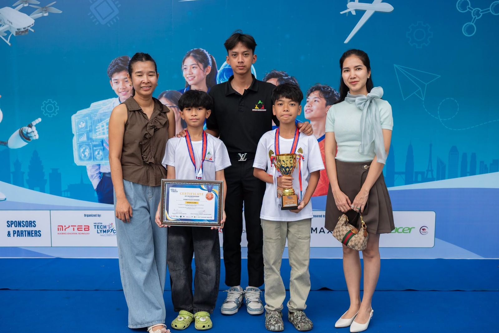 AAA Robotics students with their third-place trophy and certificate at Cambodia Techlympics 2026.