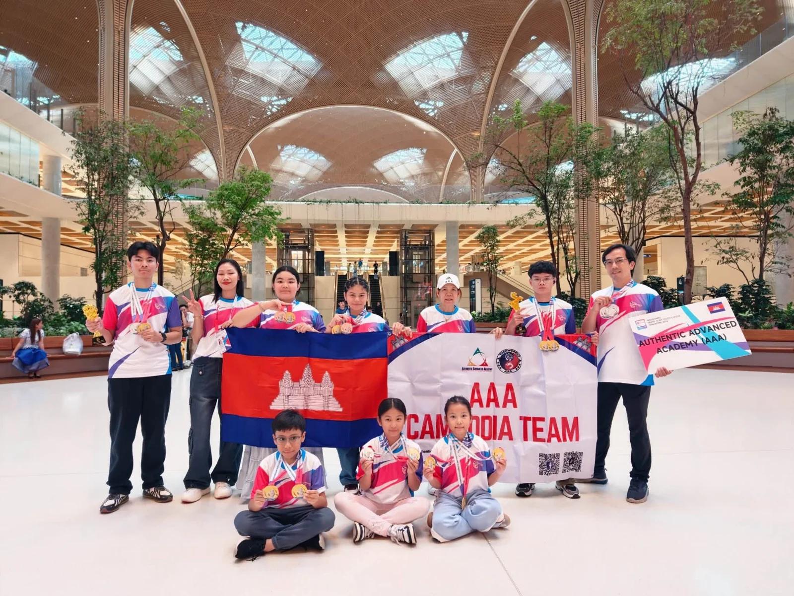 AAA’s Cambodia Taekwondo team gathers with flags at the airport after the Singapore competition.