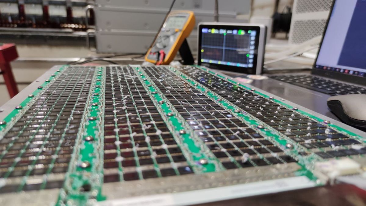 ASIC hashboard under examination at a repair workbench