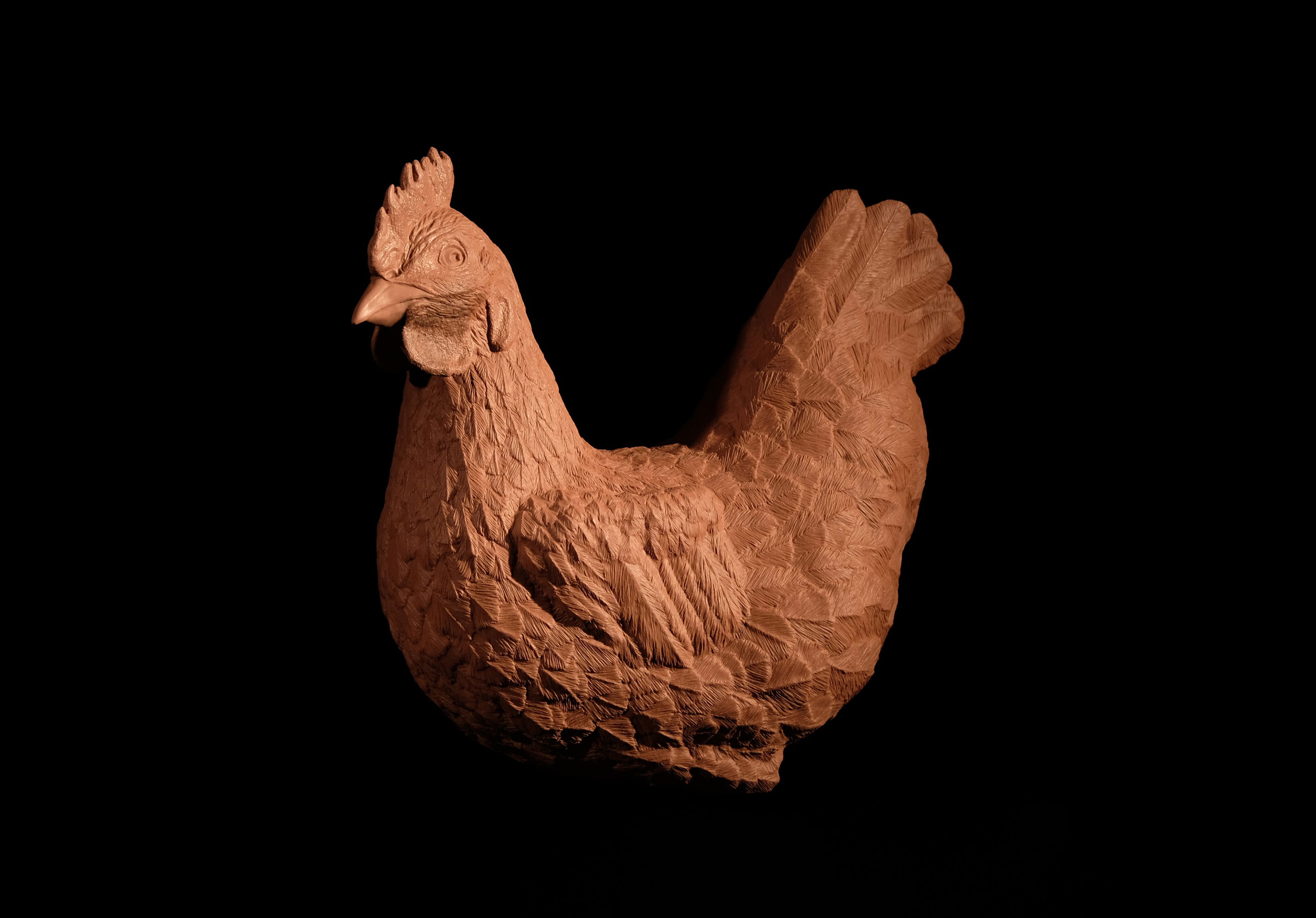 A detailed sculpture of a chicken, showcasing textured feathers and a realistic form