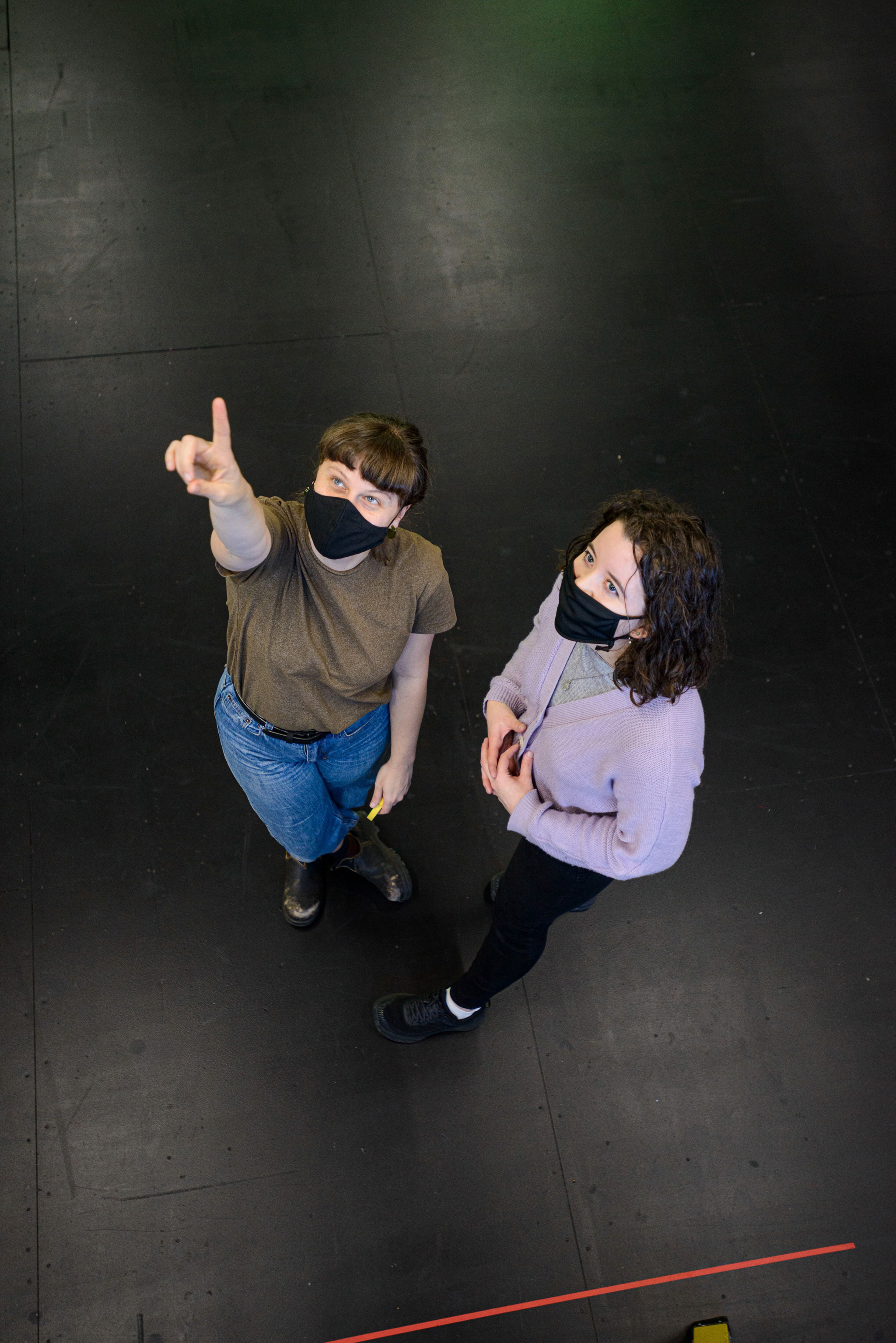 Two individuals stand on a dark theater floor, both wearing masks. One gestures upward with intent, while the other watches attentively"Rosemary is a Melbourne-based stage manager with a keen interest in collaborative and movement led processes. She holds a Bachelor of Fine Arts (Design and Production) from the Victorian College of the Arts (VCA), a Diploma in Dance (Elite Performance) and was the proud recipient of the 2020 Daryl Wilkinson Encouragement Award.

Throughout her studies at the VCA Rosemary has held diverse management roles, developing a passion for fostering sustainable and actively inclusive workspaces.

Rosemary’s VCA credits include: Stage Manager on 10 degrees; Assistant Stage Manager on pool (no water) (directed by Leticia Cáceres) and Swim Between the Flags. She also worked across multiple devised theatre productions as Assistant Production Manager and Head Electrician. In 2021 Rosemary completed internships with Malthouse Theatre on Because the Night and Michael Cassel Group’s Harry Potter and the Cursed Child."