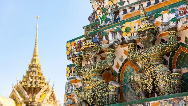 Mosaic guardian figures on the spire of Wat Arun in Bangkok