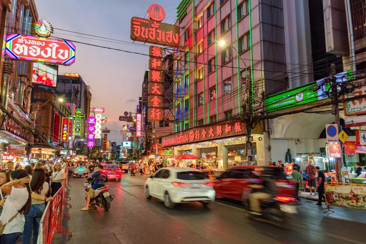 Neon signs and evening crowds along Yaowarat Road in Bangkok's Chinatown