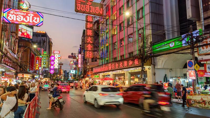 Neon signs and evening crowds along Yaowarat Road in Bangkok's Chinatown