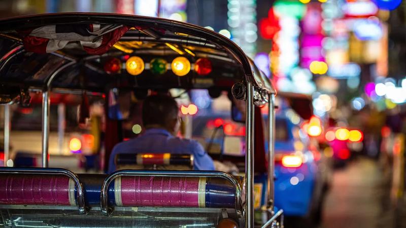 The view from a tuk-tuk in Bangkok traffic under Chinatown's neon lights