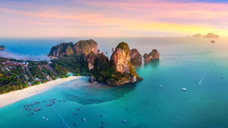 Aerial view of Railay beach and its limestone headlands at sunset, Krabi