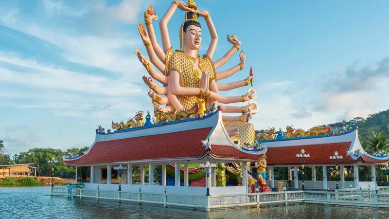 Wat Plai Laem temple on Koh Samui, its giant multi-armed Guanyin statue rising above the lake