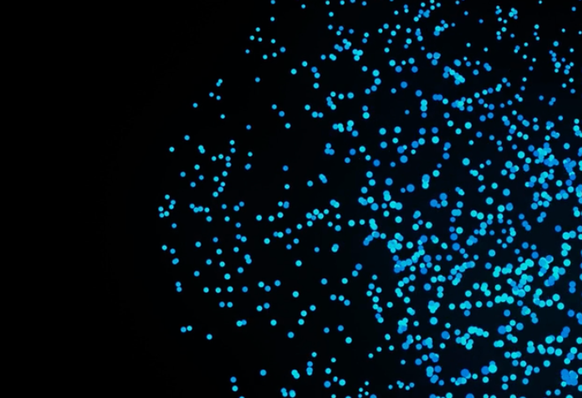 Blaue Dots auf schwarzem Hintergrund.