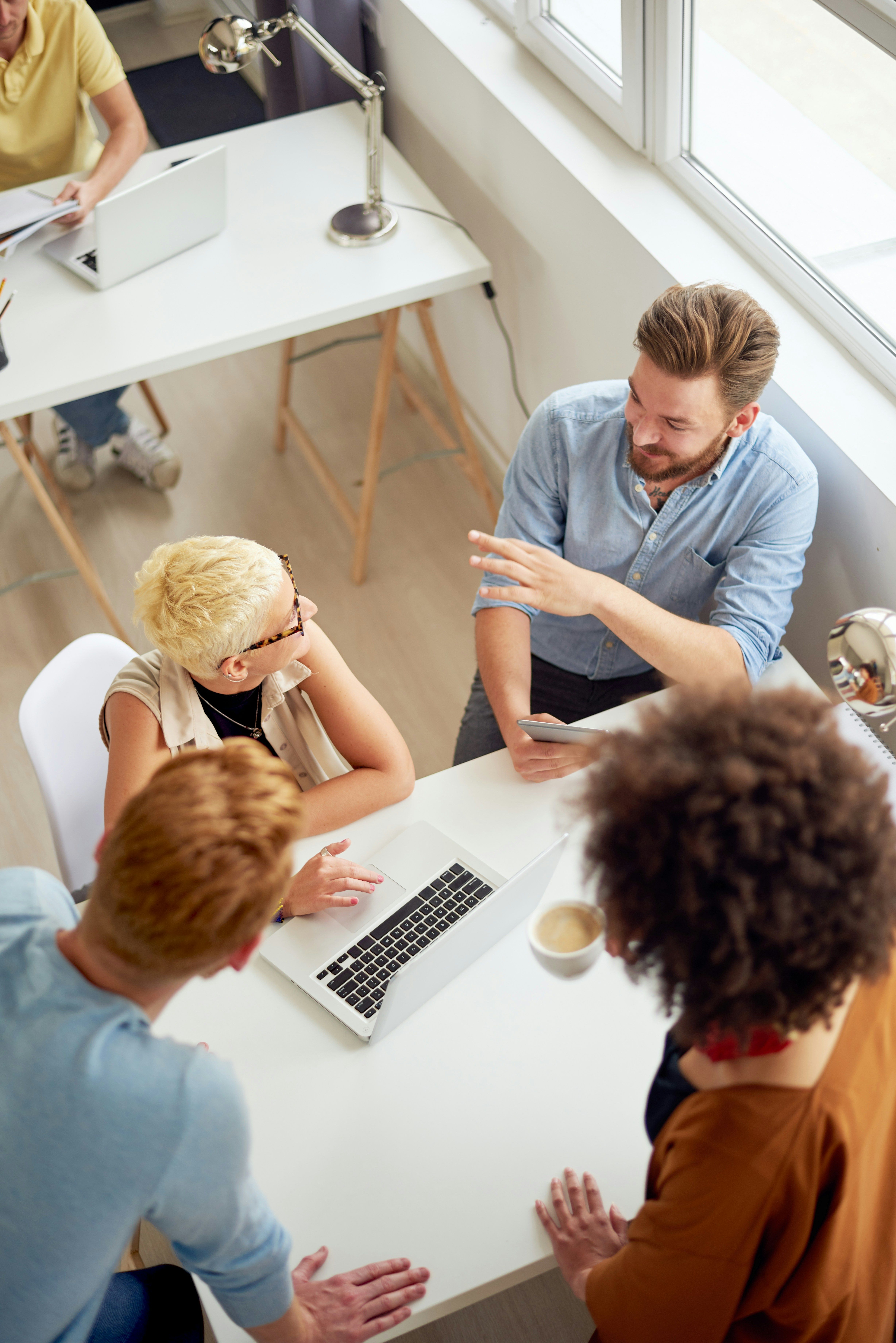 A group of colleagues gathered around a table for a meeting