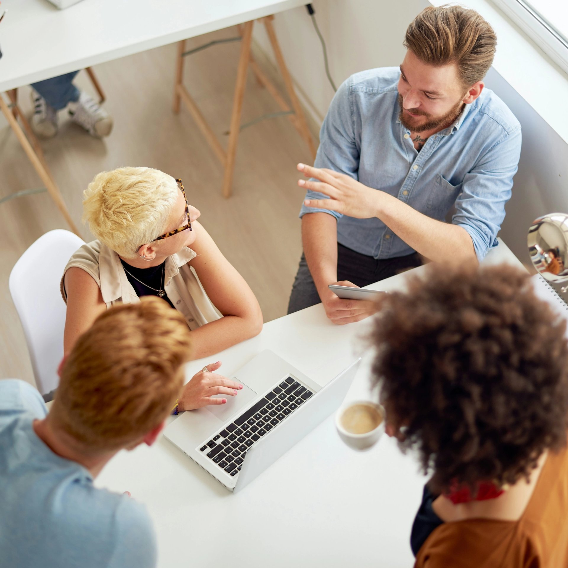 A group of colleagues gathered around a table for a meeting