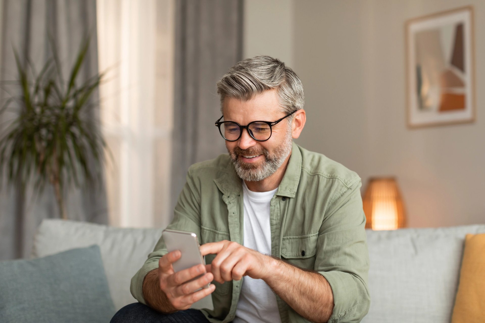 Ein Mann schaut auf sein Smartphone. 