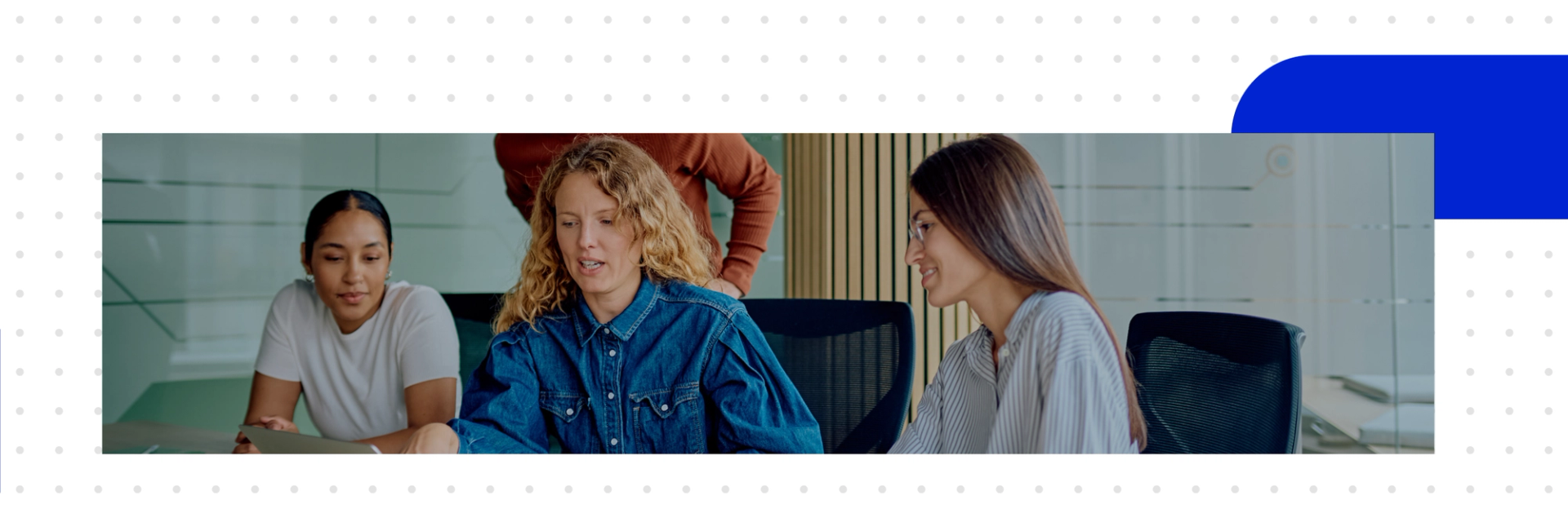 A team discusses in the office, comparing Salesforce and SAP side by side on a laptop