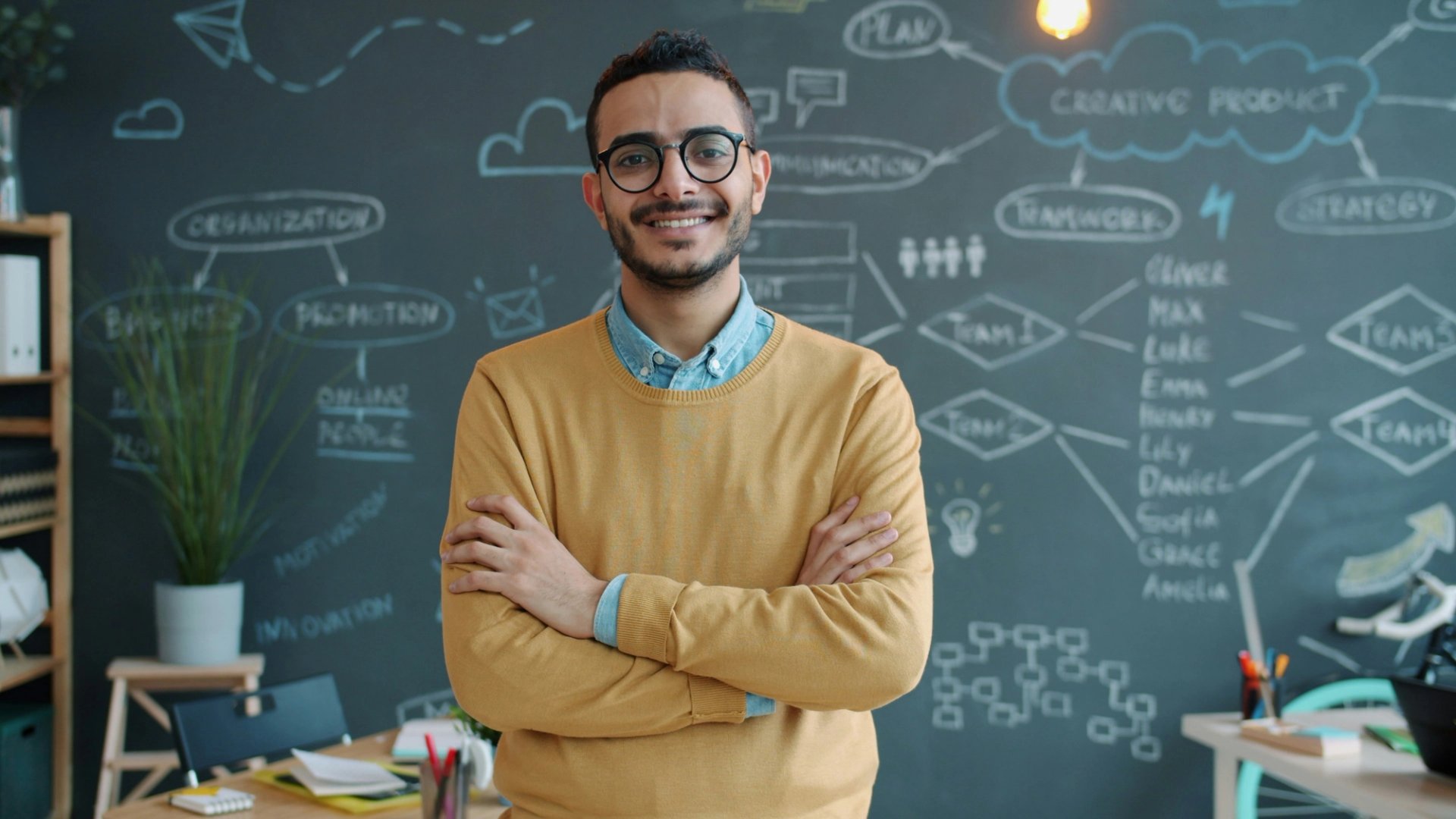 Consultant in front of a whiteboard with processes diagrammed