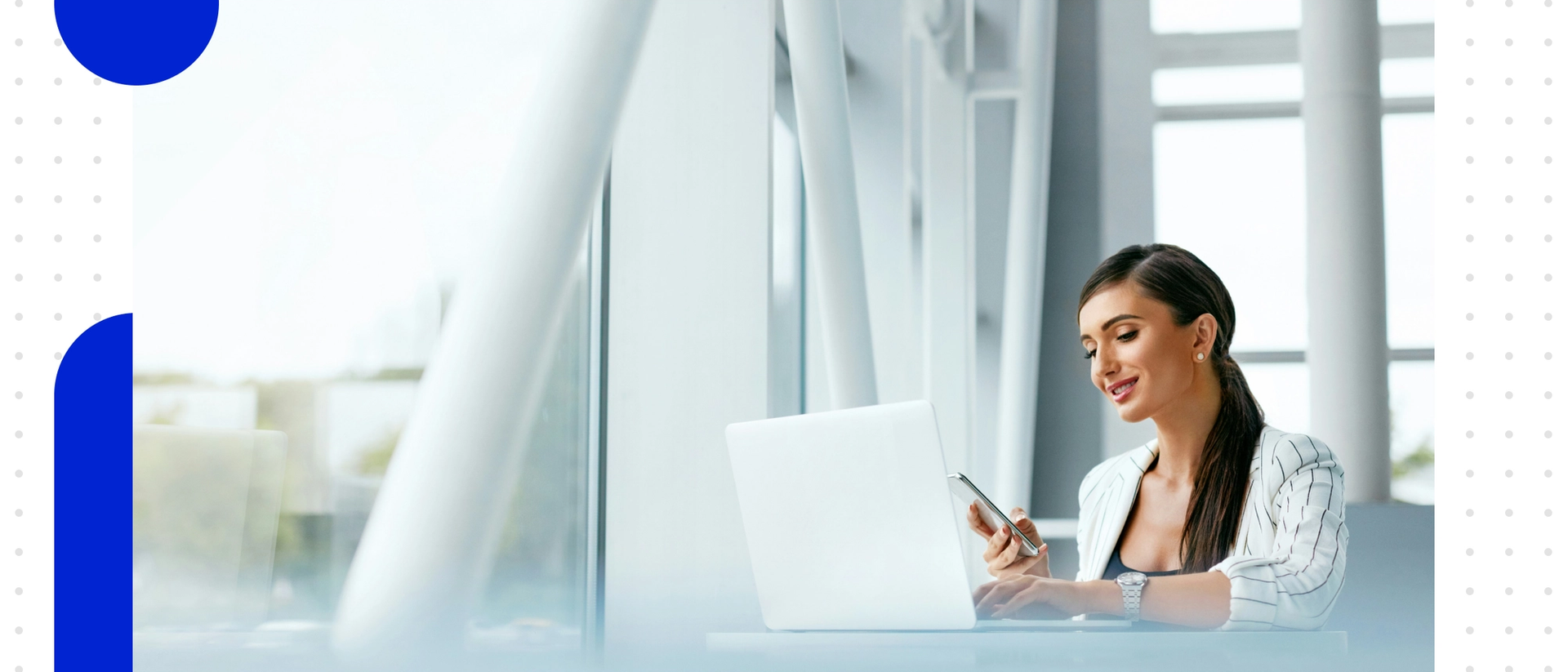 Woman on a laptop in front of a large floor-to-ceiling window front