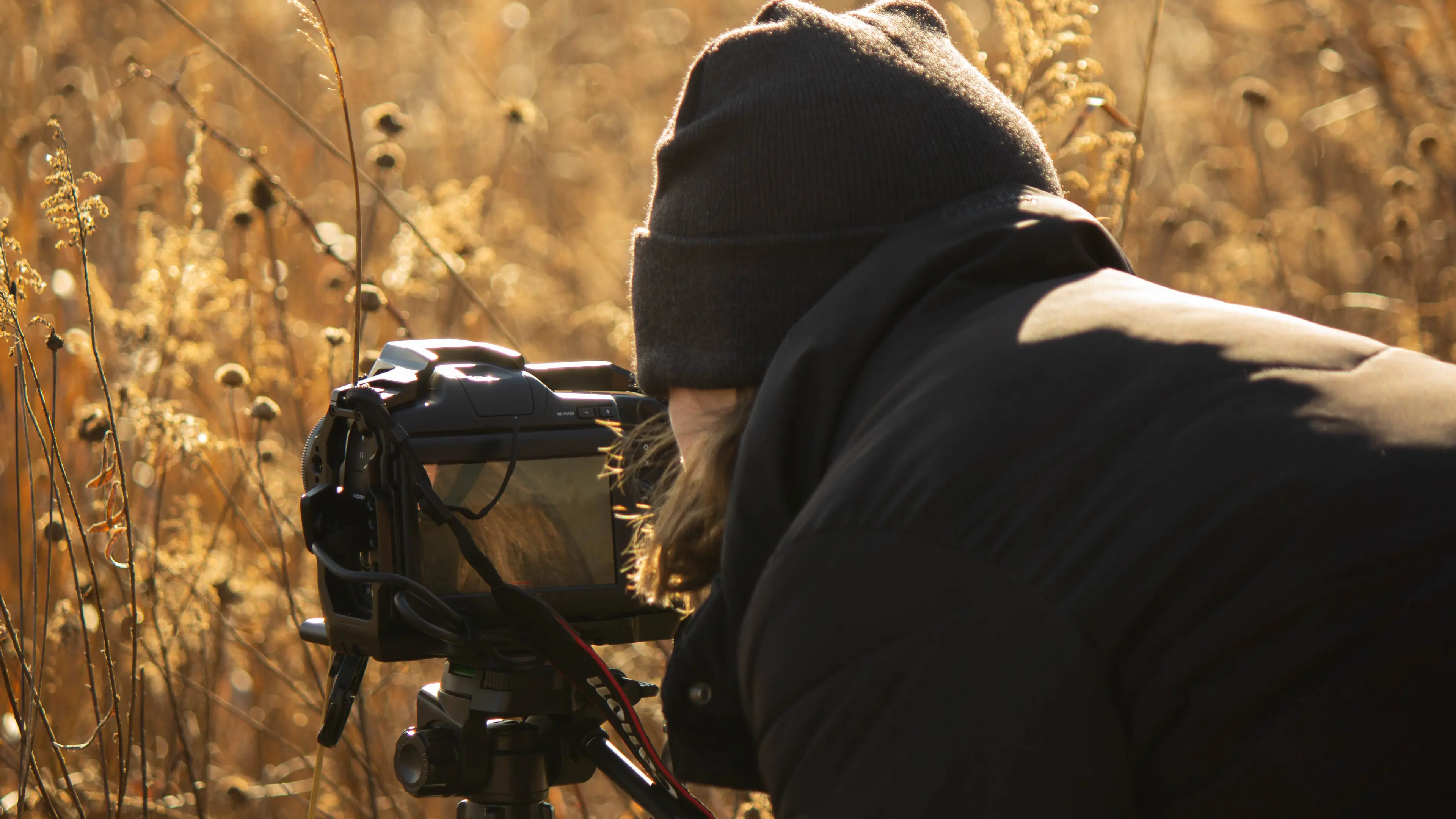 Rachel capturing some film footage of a prairie on her Blackmagic 6k Pro.
