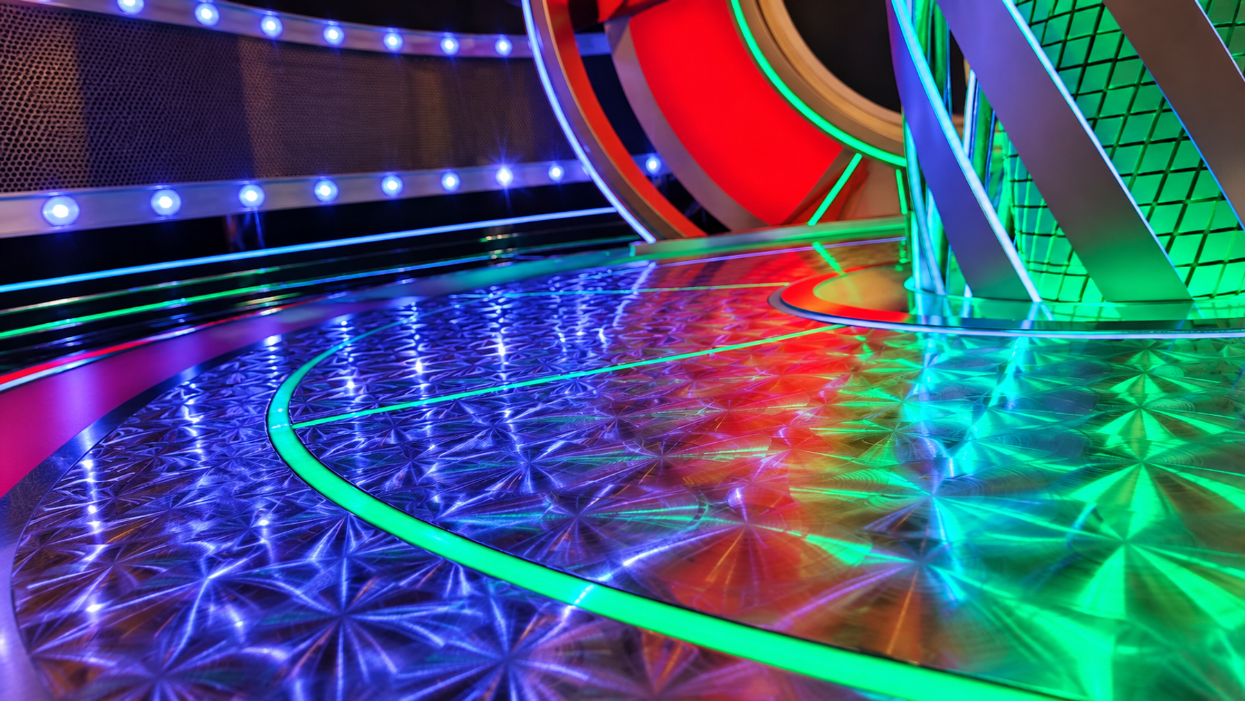 Radially brushed stainless-steel floor and central podium in a roulette studio