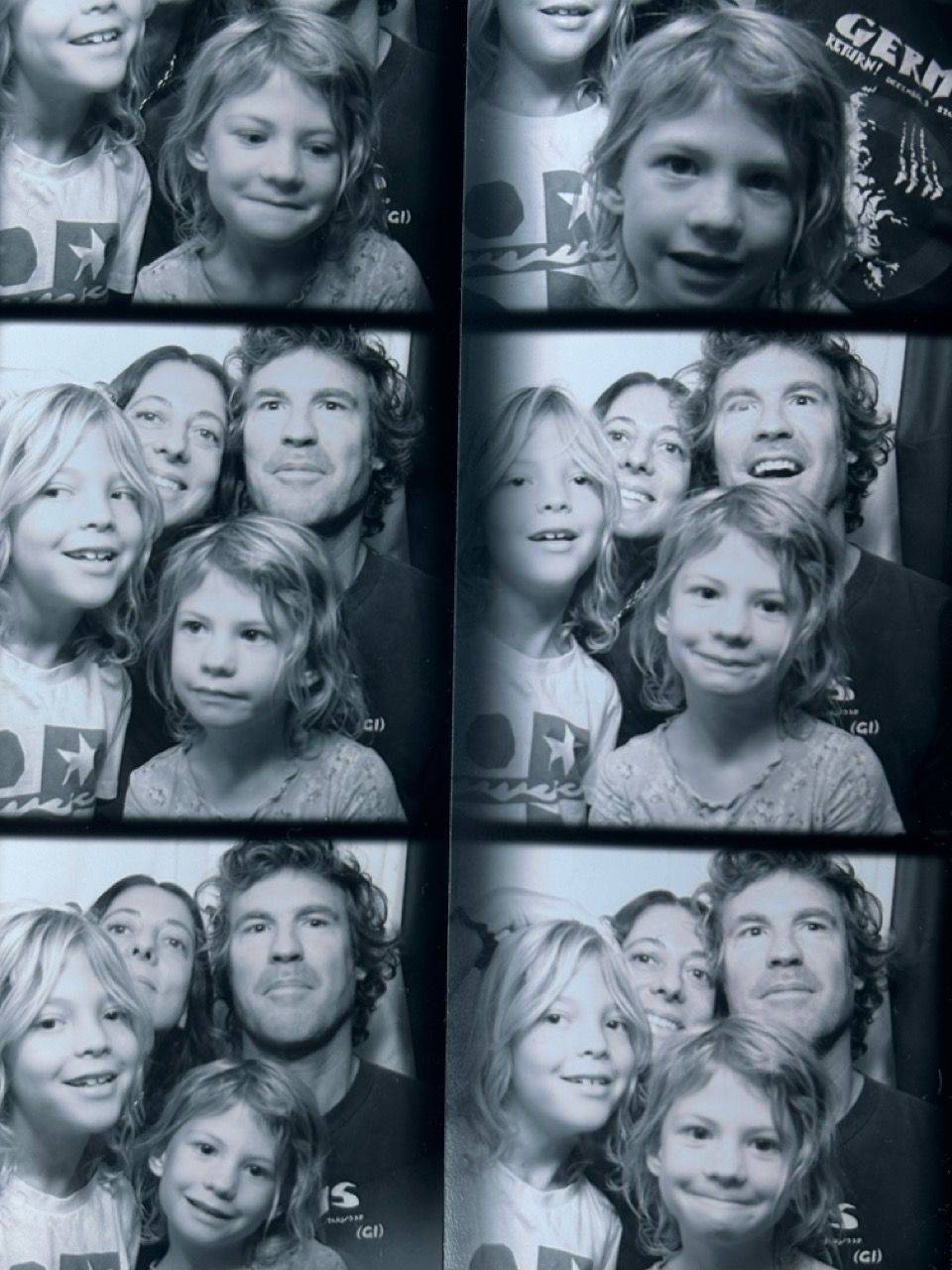 A black and white photo booth strip showing a family of four (two adults, two children) making various happy faces across multiple frames.