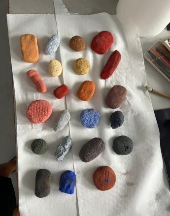 Small, colorful, textured, irregularly shaped objects are laid out on white paper towels.