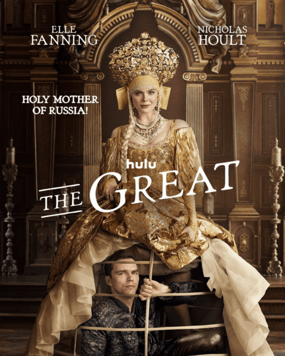 Poster for Hulu's The Great showing Elle Fanning in an elaborate gold gown and headdress, standing over Nicholas Hoult who is trapped beneath her skirt.