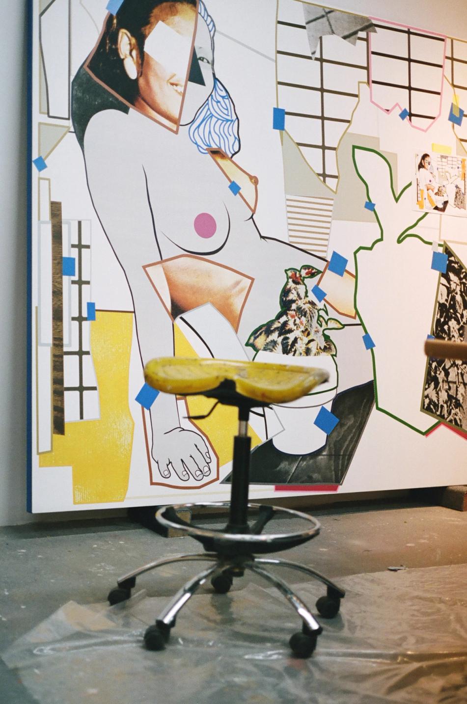 Large mixed-media collage of a partially nude female figure, with a yellow art stool in the foreground of a studio.